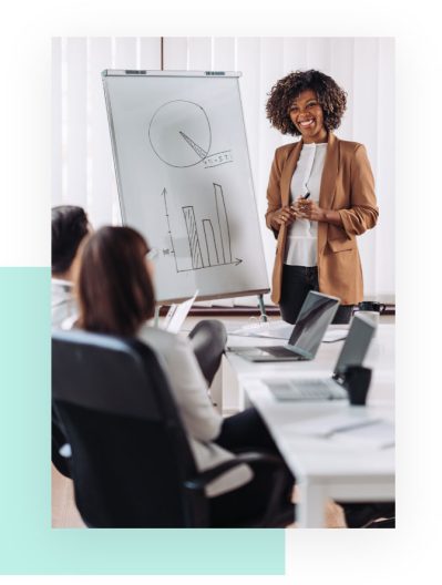 A corporate woman presenting at an executive meeting.